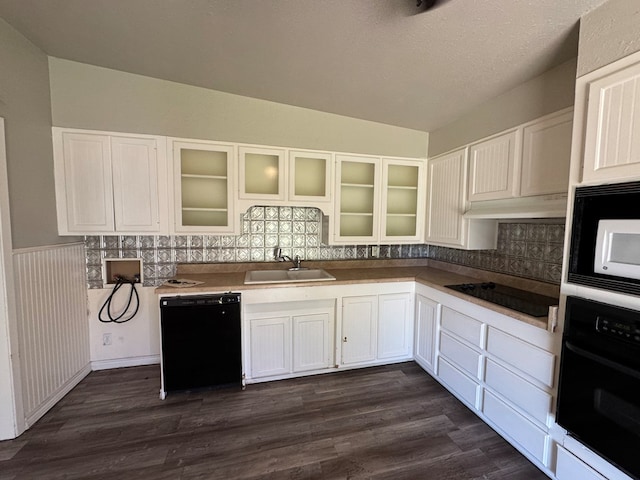 kitchen with sink, dark wood-type flooring, black appliances, a textured ceiling, and white cabinets