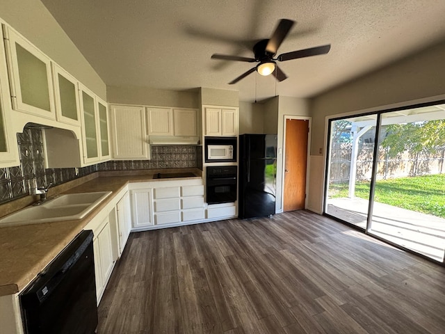 kitchen with black appliances, a textured ceiling, dark hardwood / wood-style floors, white cabinets, and backsplash