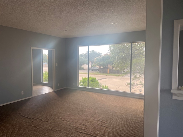 415 W Twohig Ave, San Angelo, TX 76903 - carpeted empty room with baseboards and a textured ceiling