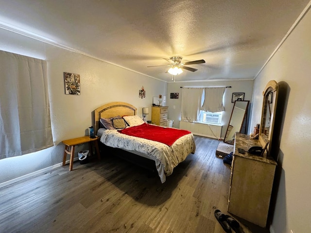 bedroom with crown molding, ceiling fan, cooling unit, a textured ceiling, and dark hardwood / wood-style flooring