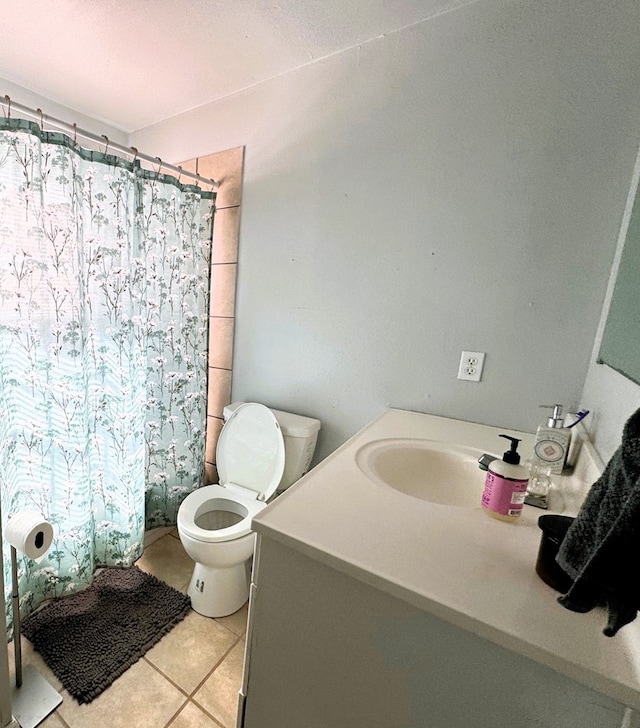 bathroom with vanity, curtained shower, tile patterned floors, and toilet