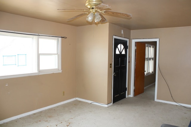 carpeted empty room featuring ceiling fan