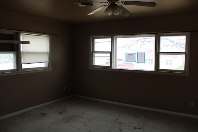 spare room featuring a wealth of natural light and ceiling fan