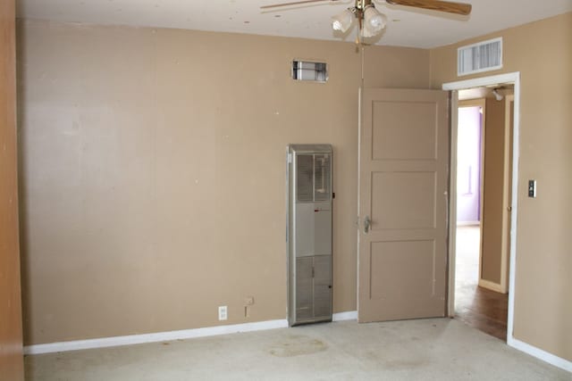 unfurnished bedroom featuring ceiling fan and light carpet