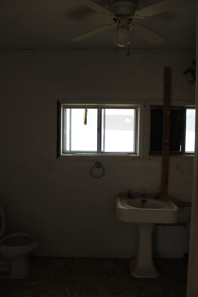 bathroom featuring tile patterned floors, a healthy amount of sunlight, and toilet