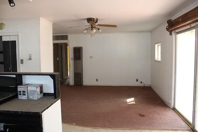 kitchen featuring ceiling fan, ornamental molding, and carpet floors