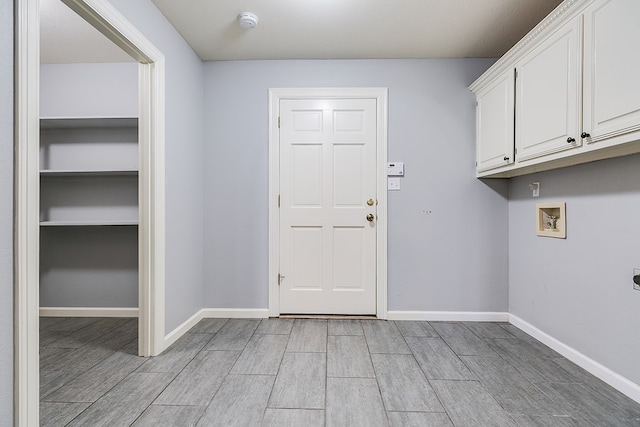 6026 Warwick Dr, San Angelo, TX 76901 - washroom with cabinet space, light wood-style floors, hookup for a washing machine, baseboards, and electric dryer hookup