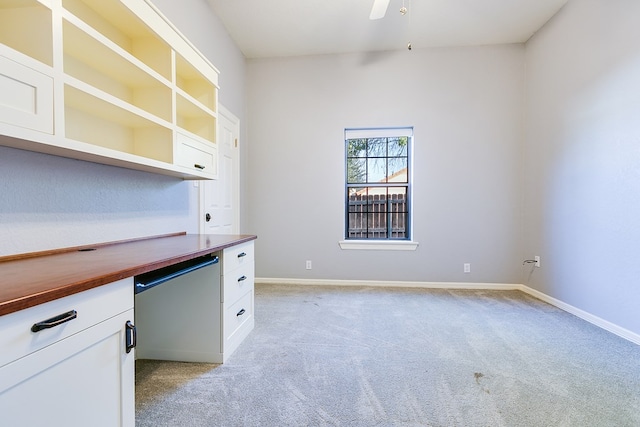 6026 Warwick Dr, San Angelo, TX 76901 - unfurnished office featuring light colored carpet, built in desk, baseboards, and a ceiling fan
