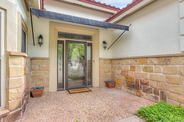 6026 Warwick Dr, San Angelo, TX 76901 - doorway to property with stucco siding and a tiled roof