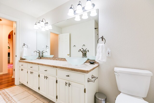 6026 Warwick Dr, San Angelo, TX 76901 - full bath with tile patterned floors, toilet, and double vanity
