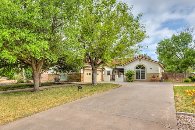 6026 Warwick Dr, San Angelo, TX 76901 - view of front of house featuring concrete driveway, a garage, and stucco siding