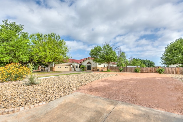 6026 Warwick Dr, San Angelo, TX 76901 - view of front of property with fence, an attached garage, driveway, and stucco siding