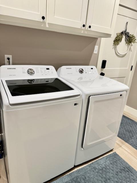 laundry room with cabinets and washer and dryer