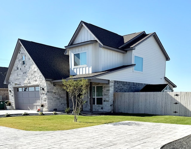 view of front of home with a garage and a front lawn