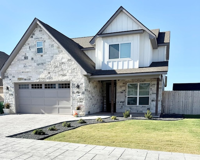 view of front of property with a garage and a front yard