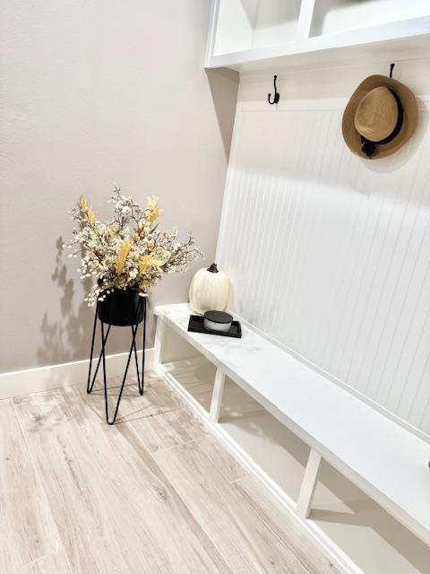 mudroom with wood-type flooring