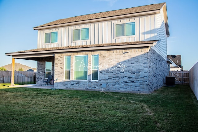 back of house with a patio, cooling unit, and a lawn