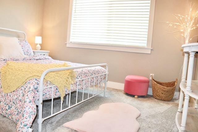 bedroom with carpet and multiple windows