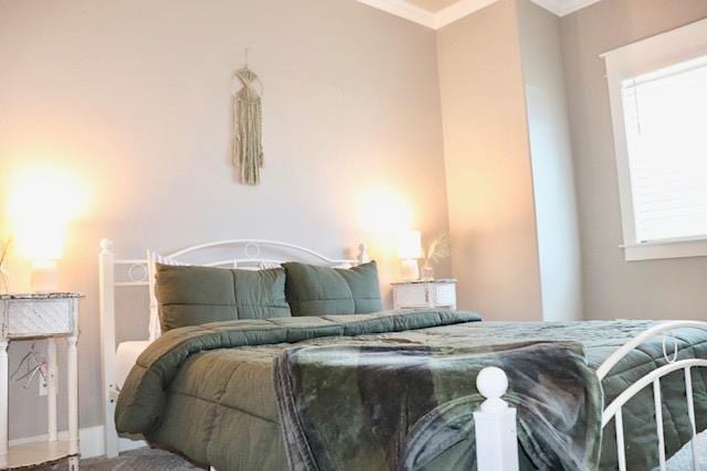 bedroom featuring multiple windows and ornamental molding