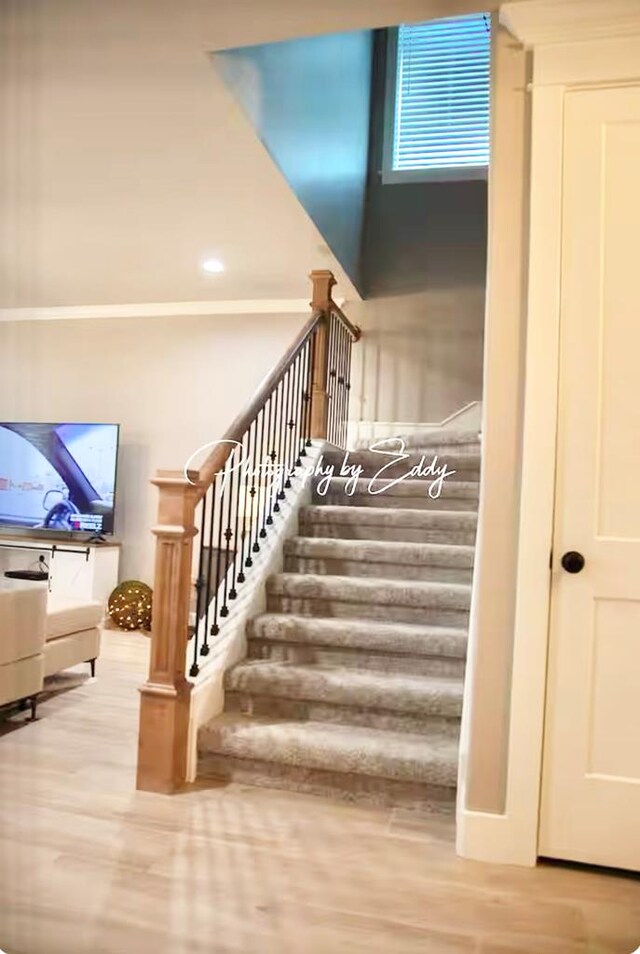 staircase with hardwood / wood-style floors