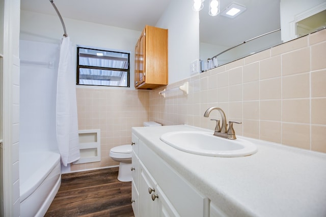 2235 Chestnut St, San Angelo, TX 76901 - full bath featuring tile walls, vanity, wood finished floors, and shower / tub combo with curtain
