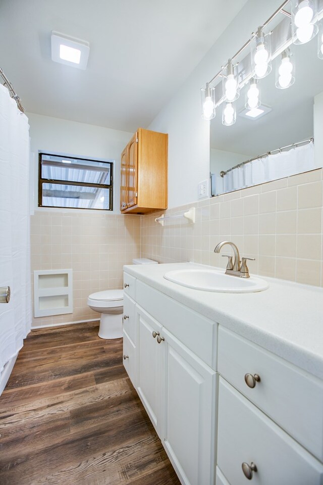 2235 Chestnut St, San Angelo, TX 76901 - full bath with tile walls, vanity, and wood finished floors