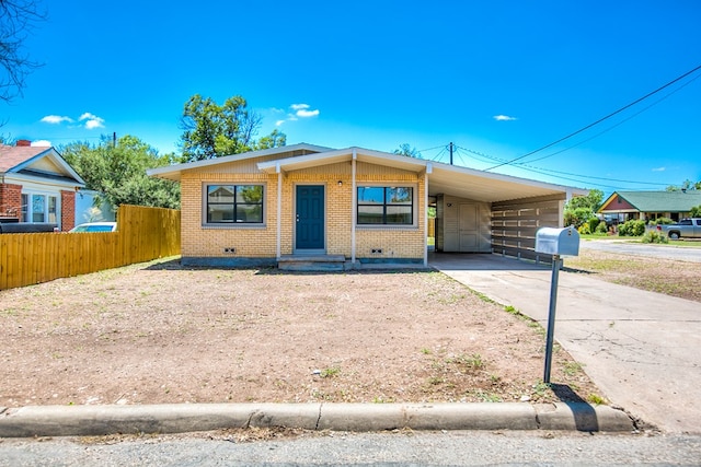 2235 Chestnut St, San Angelo, TX 76901 - view of front of property with concrete driveway, brick siding, an attached carport, and crawl space