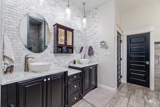 bathroom featuring vanity and backsplash