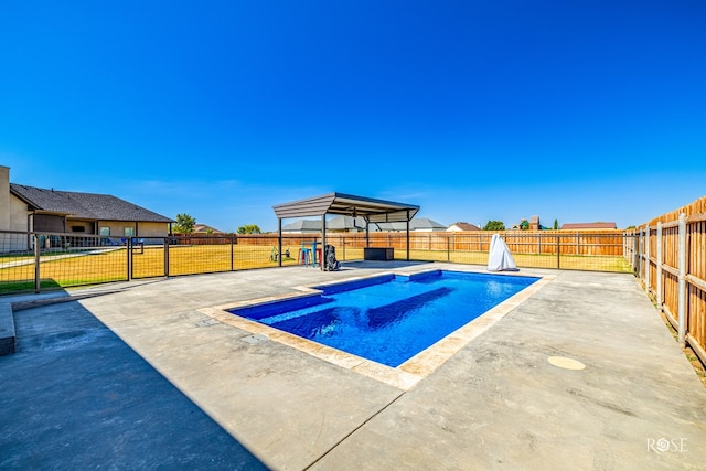 view of swimming pool featuring a patio and a yard