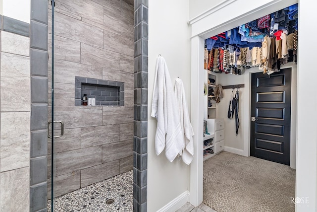 bathroom featuring a tile shower and a tile fireplace