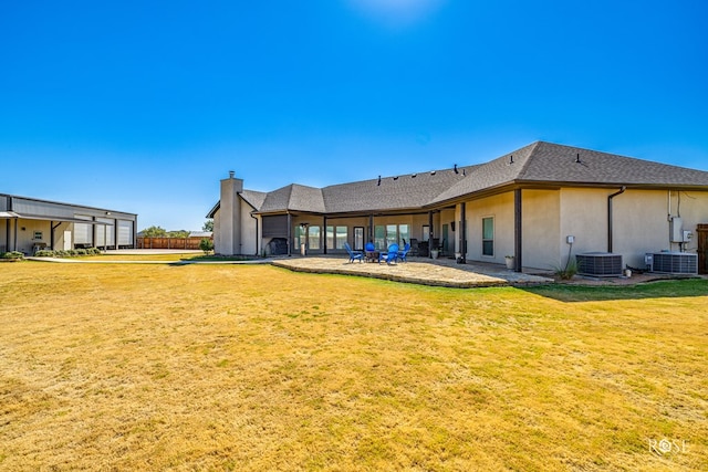 rear view of property with a lawn and a patio area