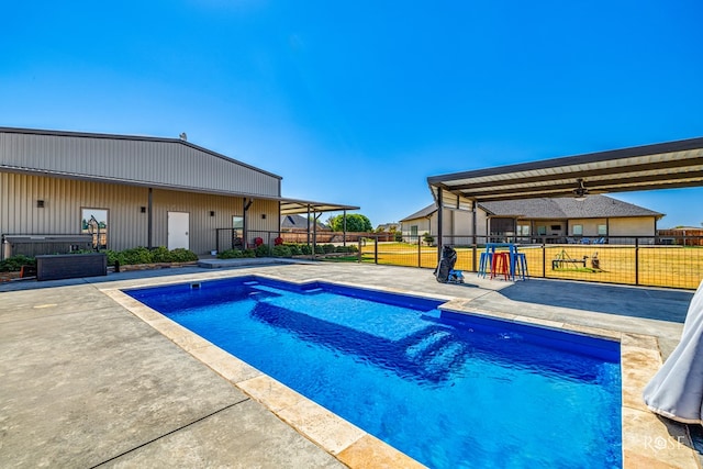 view of swimming pool featuring a yard, a patio area, and ceiling fan