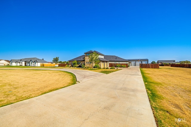 view of front of house featuring a garage and a front yard