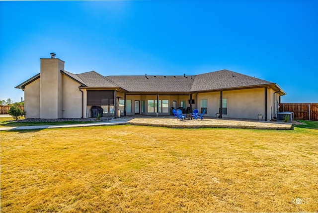 rear view of property featuring a patio, central AC unit, and a lawn