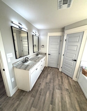 bathroom with vanity and wood-type flooring