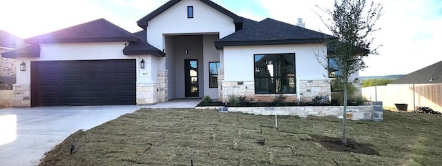 view of front of property featuring a garage and a front lawn