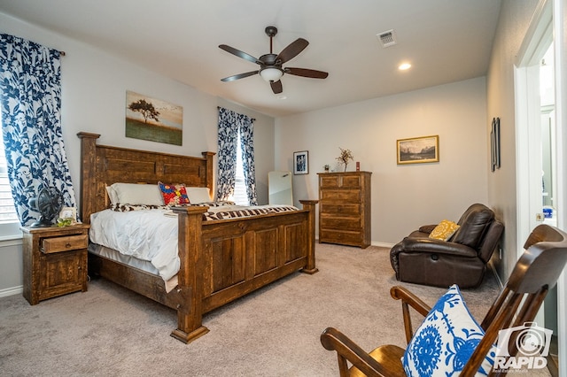 carpeted bedroom featuring multiple windows and ceiling fan