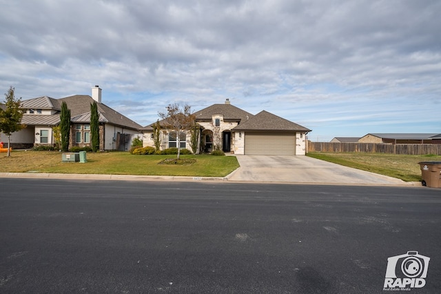 view of front facade featuring a garage and a front lawn