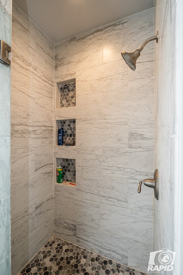 bathroom with tiled shower