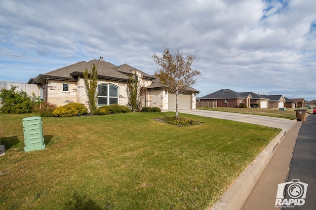 view of front facade with a garage and a front lawn