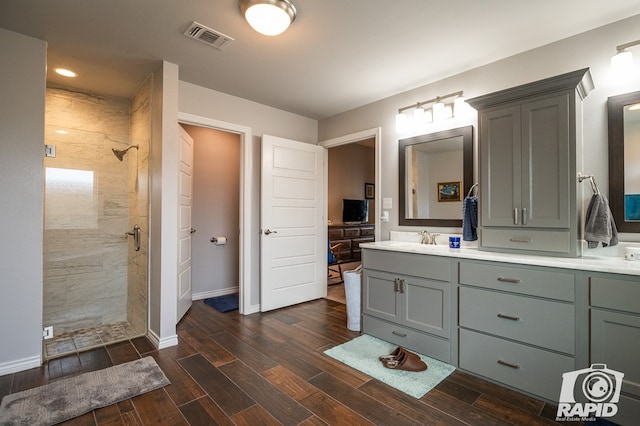 bathroom with vanity and tiled shower