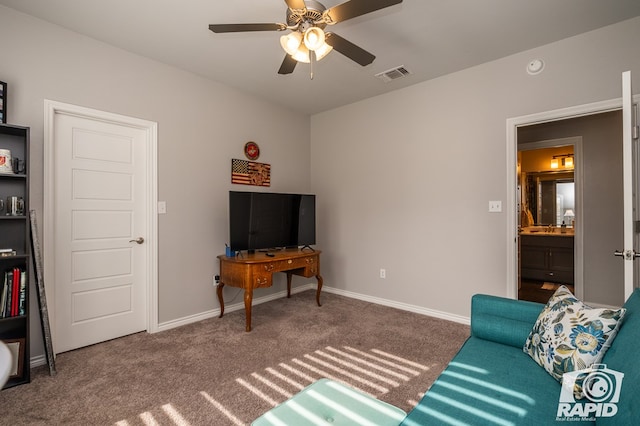 carpeted living room with ceiling fan