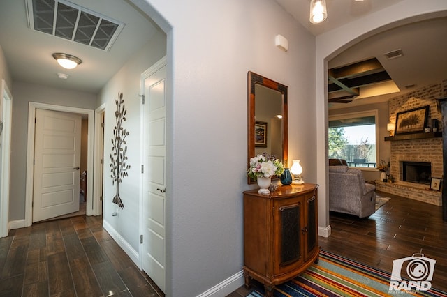 hallway featuring coffered ceiling and dark hardwood / wood-style floors