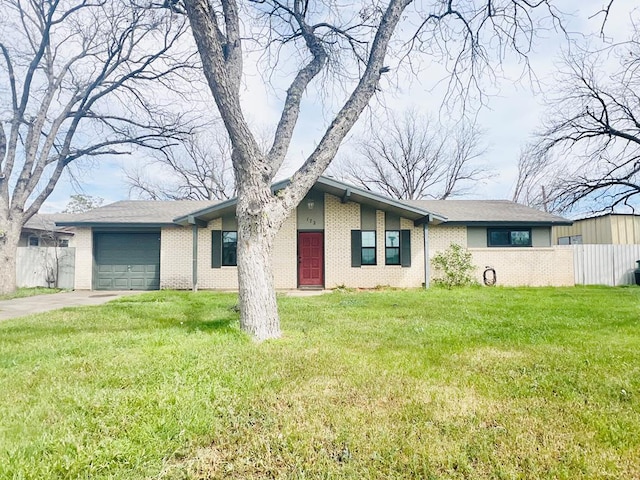 ranch-style house featuring a garage and a front yard