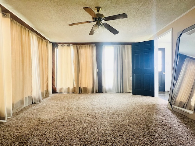 carpeted empty room with a textured ceiling