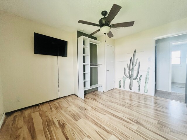 unfurnished bedroom with light hardwood / wood-style floors and ceiling fan