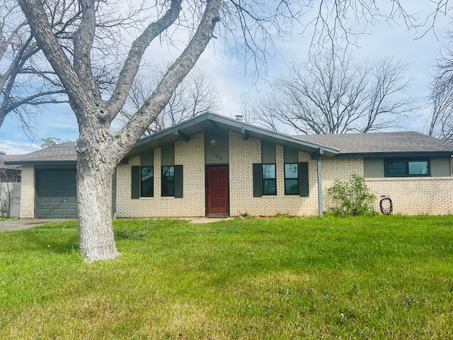 single story home featuring a garage and a front lawn