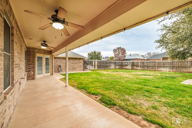 view of yard with ceiling fan and a patio area