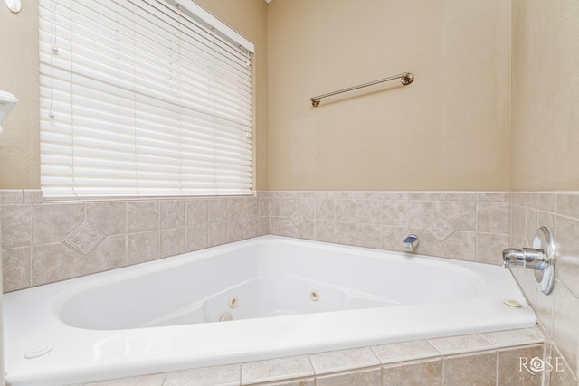 bathroom featuring tiled tub