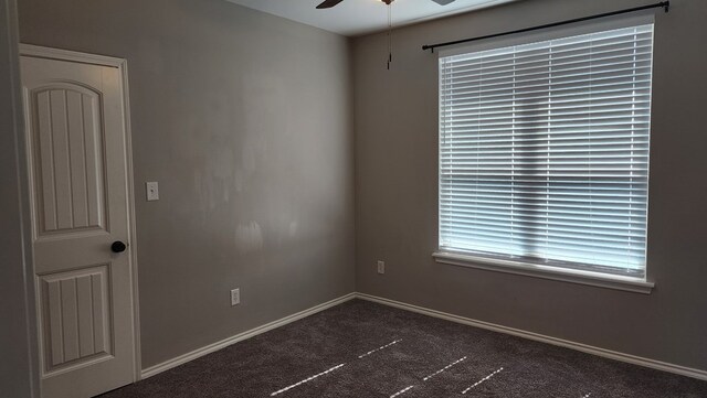 unfurnished room featuring dark carpet and ceiling fan